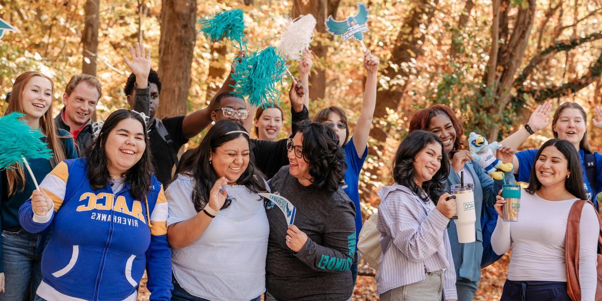 Students smiling and cheering with AACC gear.